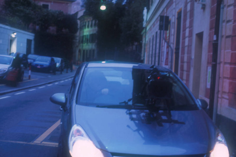 Filming crew in Turin, setting up grip for camera on the car to film driving through Turin